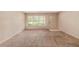 The living room boasts a large window and door, offering natural light and a view of the surrounding area at 3621 Se 12Th Pl, Ocala, FL 34471