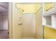 This bathroom showcases a shower with yellow and white tiling and an adjustable shower head at 3621 Se 12Th Pl, Ocala, FL 34471