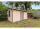 Exterior view of shed with wooden door, siding, and a small window at 3621 Se 12Th Pl, Ocala, FL 34471