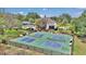 Aerial view of the property showcasing the pickleball courts, pool and outdoor living areas at 4550 County Road 104, Oxford, FL 34484