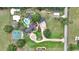 Bird's eye view of a property with a large home, swimming pool, tennis court, and circular driveway at 4550 County Road 104, Oxford, FL 34484