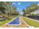 This backyard showcases shuffleboard, bocce ball, and pristine landscaping, perfect for outdoor recreation and entertaining at 4550 County Road 104, Oxford, FL 34484