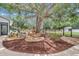 A stunning backyard features a unique decorative element with mature trees and landscaping at 4550 County Road 104, Oxford, FL 34484