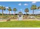 A beautiful gazebo in a lush backyard with a pond and fountain features bridge access at 4550 County Road 104, Oxford, FL 34484