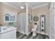 A cozy bathroom with a shower, vanity, and nautical decor at 4550 County Road 104, Oxford, FL 34484