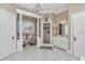 Luxurious primary bathroom featuring a chandelier, marble counters, and a walk-in shower at 4550 County Road 104, Oxford, FL 34484