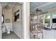 Bathroom next to porch with a unique barrel sink and chandelier at 4550 County Road 104, Oxford, FL 34484