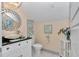 Stylish bathroom with modern vanity, decorative mirror, and elegant fixtures for a luxurious experience at 4550 County Road 104, Oxford, FL 34484