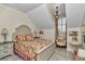 Bedroom with floral patterned bedding, chair, shuttered window and grey toned floors at 4550 County Road 104, Oxford, FL 34484