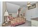 Bright bedroom with sloped ceilings, chandelier, and a cozy floral patterned comforter at 4550 County Road 104, Oxford, FL 34484