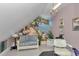 Cozy bonus room with sloped ceiling, scenic mural, and elegant chandelier at 4550 County Road 104, Oxford, FL 34484