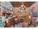 Rustic den with wood paneling, exposed brick, and vintage decor at 4550 County Road 104, Oxford, FL 34484