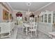 Elegant dining room with a chandelier, white furniture, and decorative details at 4550 County Road 104, Oxford, FL 34484