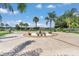 Circular driveway featuring a fountain, surrounding benches, and beautifully landscaped grounds at 4550 County Road 104, Oxford, FL 34484