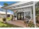 Charming beach cabin features a covered porch with seating and landscaped yard at 4550 County Road 104, Oxford, FL 34484