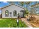 Charming exterior with arched windows, manicured lawn and pathway leading to the front door at 4550 County Road 104, Oxford, FL 34484