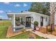 Charming exterior with covered porch, seating area, and inviting walkway at 4550 County Road 104, Oxford, FL 34484