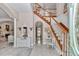 Grand foyer featuring elegant staircase, tile floors, and decorative details at 4550 County Road 104, Oxford, FL 34484