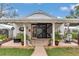 Charming home exterior with decorative sliding door and covered porch at 4550 County Road 104, Oxford, FL 34484