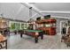 Entertainment space with pool table, bar, and stone accent wall at 4550 County Road 104, Oxford, FL 34484