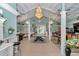 Large game room with multiple chandeliers, tables, and bar stools at 4550 County Road 104, Oxford, FL 34484