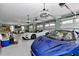 Spacious garage with multiple car capacity, featuring modern lighting and ample space for vehicle storage at 4550 County Road 104, Oxford, FL 34484