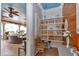 Hallway featuring built-in shelves and a glimpse into the outdoor living space with chandeliers at 4550 County Road 104, Oxford, FL 34484