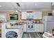 Bright kitchen with white cabinets, modern appliances, and open layout at 4550 County Road 104, Oxford, FL 34484