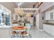 Open kitchen and dining area with high ceilings, large windows, and stylish chandeliers at 4550 County Road 104, Oxford, FL 34484