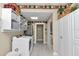 Bright laundry area with white cabinets, shelving, and modern washer and dryer at 4550 County Road 104, Oxford, FL 34484