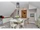 Living room area with a table and chairs, stairs, and pendant lights at 4550 County Road 104, Oxford, FL 34484