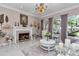 Cozy living room with a fireplace, large windows, and comfortable seating at 4550 County Road 104, Oxford, FL 34484