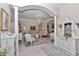 Elegant living room with ornate columns, chandelier, and neutral color palette at 4550 County Road 104, Oxford, FL 34484