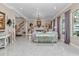 Spacious living room with fireplace, floral sofa, and view to foyer at 4550 County Road 104, Oxford, FL 34484