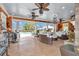 Expansive covered outdoor living space with chandeliers, tile flooring and view of the sparkling pool at 4550 County Road 104, Oxford, FL 34484