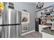 A well-organized pantry features a stainless steel refrigerator and floating shelves at 4550 County Road 104, Oxford, FL 34484