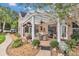 Covered patio featuring stylish furniture and manicured landscaping, ideal for outdoor relaxation at 4550 County Road 104, Oxford, FL 34484