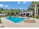 Beautiful pool with lounge areas and a covered cabana, surrounded by mature trees and landscaping at 4550 County Road 104, Oxford, FL 34484