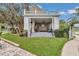 Inviting porch with white columns, comfortable seating, and manicured lawn at 4550 County Road 104, Oxford, FL 34484