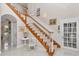 Elegant staircase featuring wooden steps, white railings, and bright lighting at 4550 County Road 104, Oxford, FL 34484
