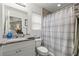 Well-lit bathroom with a shower-tub combo, granite countertop vanity, and mirror offers both style and functionality at 5063 Se 168Th Ter, Ocklawaha, FL 32179