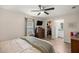 Comfortable bedroom with ceiling fan, dresser, and walk-in closet provides an organized and serene atmosphere at 5063 Se 168Th Ter, Ocklawaha, FL 32179