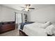 This bedroom has a ceiling fan, hard surface floors, a window, and a dresser for practical comfort and charm at 5063 Se 168Th Ter, Ocklawaha, FL 32179