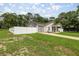 Single-story home featuring a garage, fenced yard, and well-kept lawn at 5063 Se 168Th Ter, Ocklawaha, FL 32179
