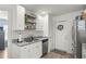 Bright kitchen with stainless steel appliances, floating shelves, and granite countertops offers ample storage and style at 5063 Se 168Th Ter, Ocklawaha, FL 32179
