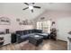 Bright living room with vaulted ceilings, a large sectional sofa, and wood laminate flooring at 5063 Se 168Th Ter, Ocklawaha, FL 32179