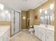 Bathroom featuring dual vanities, glass shower, tile floors, and neutral color scheme at 5445 Ne Anthony Rd, Ocala, FL 34475