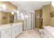 Bathroom with dual vanity, a glass-enclosed shower, and tiled flooring at 5445 Ne Anthony Rd, Ocala, FL 34475
