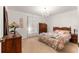 Bedroom featuring carpeted floors, wood furniture, chandelier and large window adding a cozy feel at 5445 Ne Anthony Rd, Ocala, FL 34475