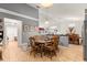 The dining area features a vaulted ceiling, tile floors, and an eat-in space with a round wooden table at 5445 Ne Anthony Rd, Ocala, FL 34475